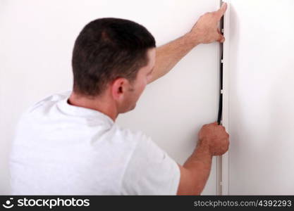 An electrician installing wire.