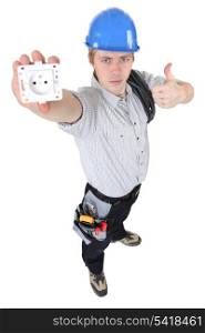 An electrician presenting an outlet.