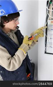 An electrician repairing a distribution board