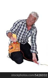 An electrocuted tradesman staring at his multimeter