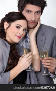 An elegant couple celebrating with a toast