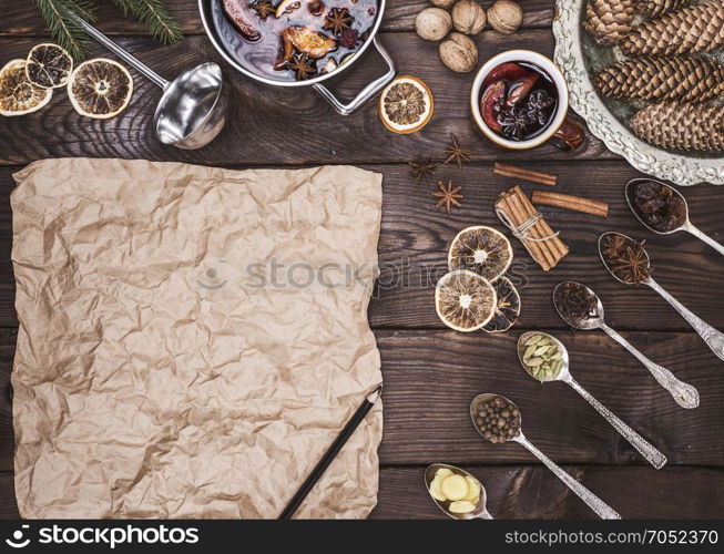 an empty brown sheet of paper with a black pencil to record the mulled wine recipe and ingredients of an alcoholic beverage