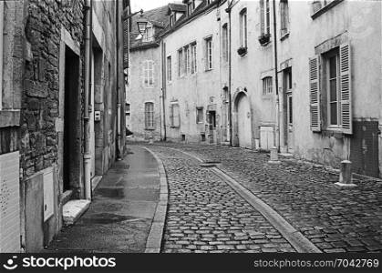 An empty, quiet street in Beaune during the middle of the day shows the character of the old city. (Scanned from black and white film.)