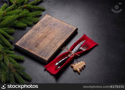 An empty wooden cutting board with wooden cutlery. Preparing the christmas kitchen table for cooking. An empty wooden cutting board with wooden cutlery on a christmas kitchen table