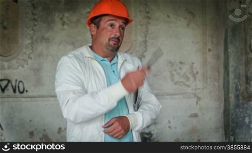 An Engineer Is Explaining Builders Work. RAW Video