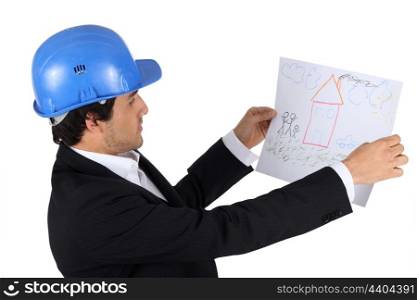 An engineer looking at a child&rsquo;s drawing