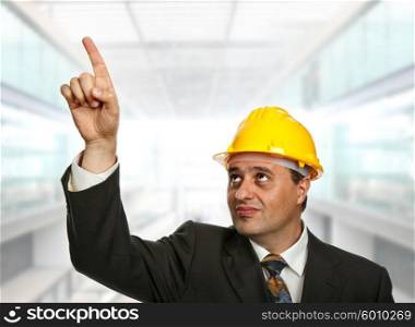 An engineer pointing up, at the office