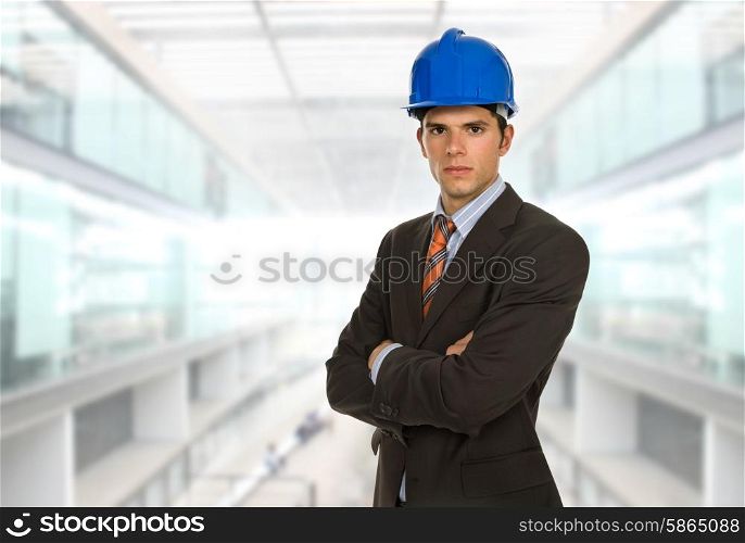 An engineer with blue hardhat at the office