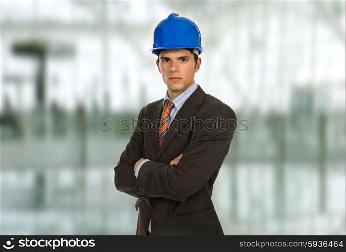 An engineer with blue hardhat at the office