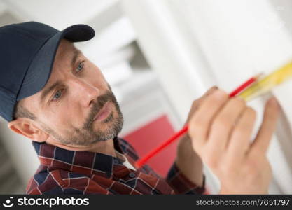 an engineer with tape measure