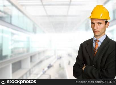 An engineer with yellow hat at the office
