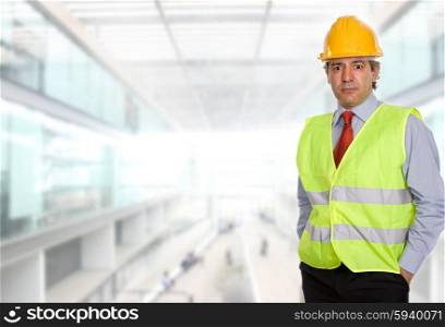 An engineer with yellow hat, at the office