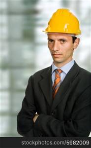 An engineer with yellow hat at the office