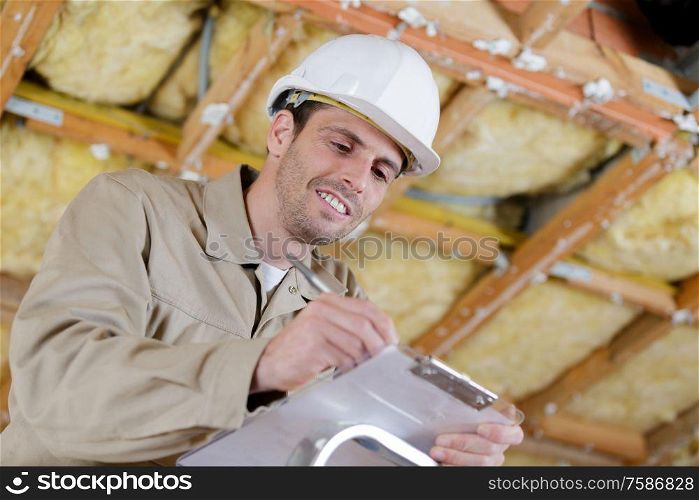 an engineer writting on clipboard