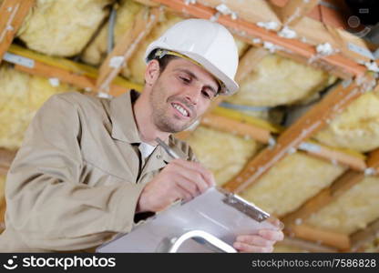 an engineer writting on clipboard