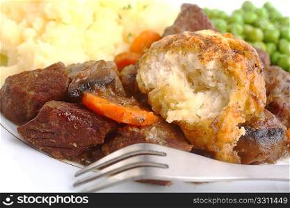 An English-style beef and carrot stew with a dumpling, served with mashed parsley potatoes and boiled green peas.