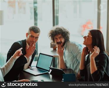 an entertaining portrait of young entrepreneurs sitting in a modern office and using modern devices. a crazy portrait of a group of entrepreneurs sitting in a modern office.