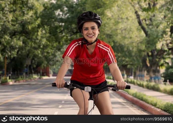 AN ENTHUSIASTIC YOUNG WOMAN RIDING A BICYCLE