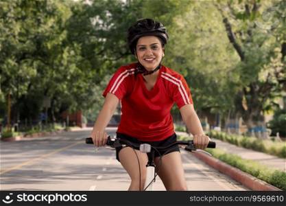 AN ENTHUSIASTIC YOUNG WOMAN RIDING A BICYCLE