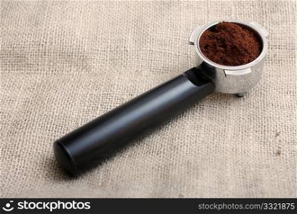 An espresso handle filled with ground coffee