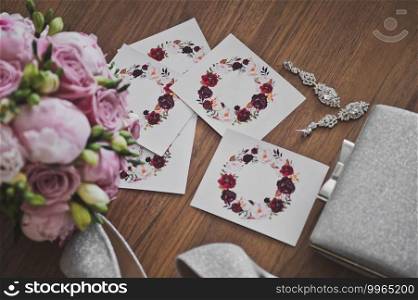 An ex&le of the design of a wedding table for the bride and groom at a festive Banquet.. A bouquet of roses and wedding decorations are on the table 2628.
