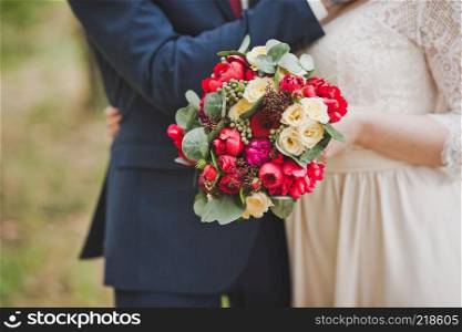 An example of a wedding bouquet in bright red and beige colors.. Photography is bright and unusual bouquet 1571.