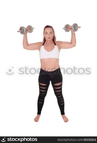 An exercising pretty woman standing in workout outfits and lofting up the two dumbbells in her hand, isolated for white background