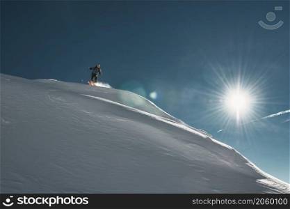 An extreme skier man tackles a fresh snow slope