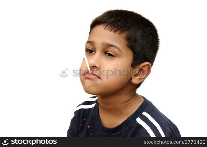 an handsome Indian kid having dun savoring a lollypop