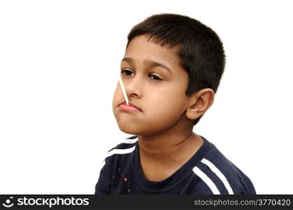 an handsome Indian kid having dun savoring a lollypop