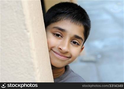 an handsome indian kid smiling happily for you