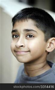 an handsome indian kid smiling happily for you