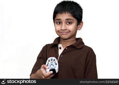 an handsome Indian kid switching on the television with a remote