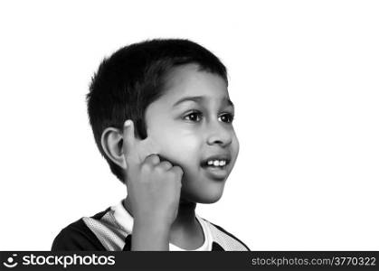 an handsome young indian kid thinking about something. Thinking