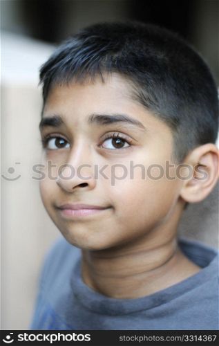 an handsome young indian man posing for the camera