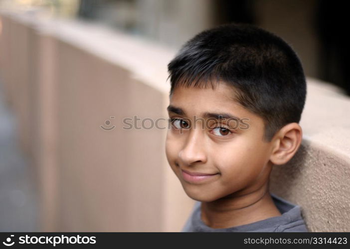 an handsome young indian man posing for the camera