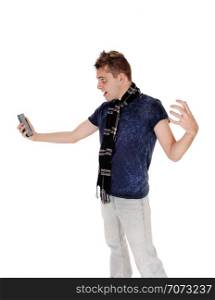 An handsome young man standing in gray jeans and blue shirt looking at his cell phone and is shocked, isolated for white background