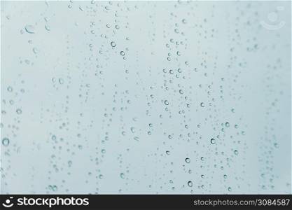 An horizontal background of some rain drops over a crystal surface
