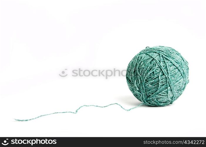 An image of a ball of green yarn on white background