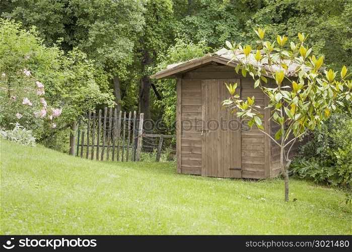 An image of a garden hut and an old gate