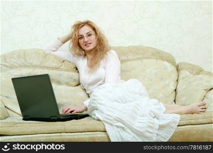 An image of a girl in glasses with laptop