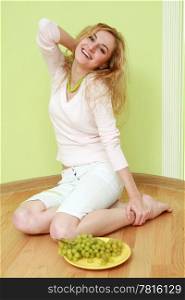 An image of a girl with a bunch of grapes on plate
