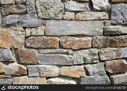 An image of a grey wall of stone