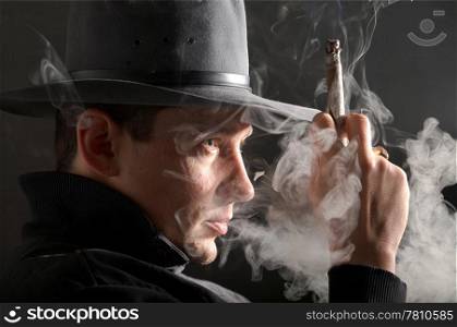 An image of a man smoking in dark room