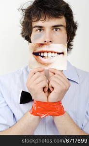 An image of a man with tape on his hands and a photo of a smile