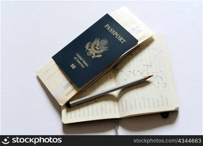 An image of a passport, tickets and a notebook
