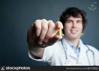 An image of a pill in a doctor&rsquo;s hand