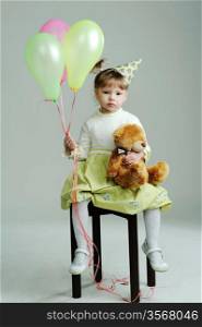 An image of a portrait of a little girl with teddy-bear