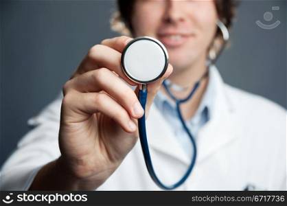 An image of a stethoscope in a doctor&rsquo;s hand