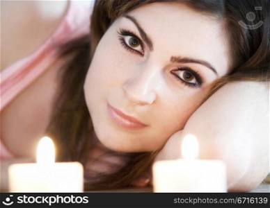 An image of a woman with two candles